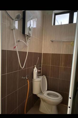 a bathroom with a toilet and a shower at SMZ Café & Homestay - SELF CHECK IN in Kodiang