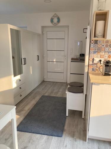 a living room with a door and a kitchen at Apartmán Nad Přehradou in Frýdek-Místek
