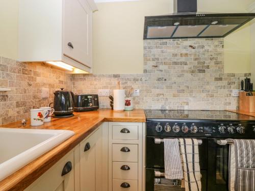 a kitchen with a stove and a sink at The Lodge in Blairgowrie