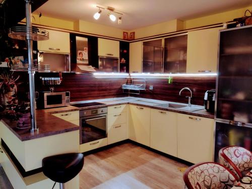 a kitchen with white cabinets and a sink at Guest house near Varna in Varna City
