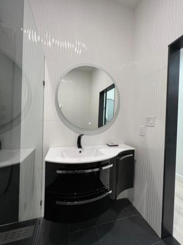a bathroom with a sink and a mirror at Elaine's Cape May Boutique Hotel in Cape May