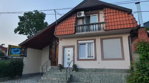 a small house with a red roof at Apartmani Odmor i Mir in Vranje