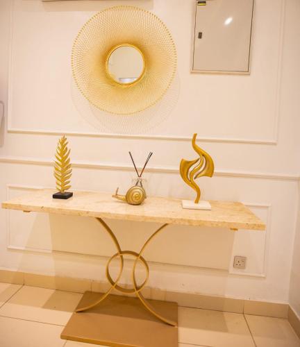 a table with a rattan hat on a wall at Prosbel Hotel in Abuja