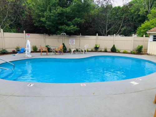 a large blue pool with a table and chairs at Best Western West Lebanon-Hanover in West Lebanon