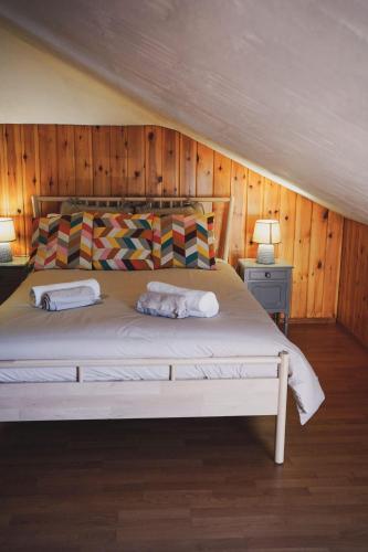 a bedroom with a large bed with wooden walls at Casa do Avô Horácio in Viana do Castelo