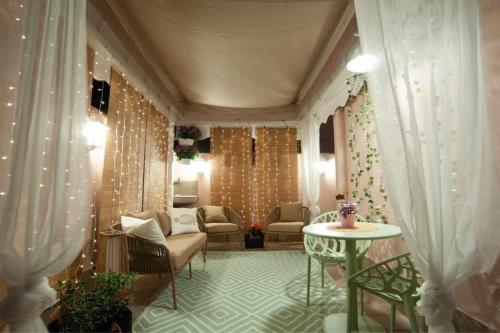a living room with a couch and a table at Charming and Cozy House in Nettuno