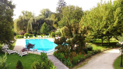 an image of a swimming pool in a garden at Batthyány Kastélyszálló in Zalacsány