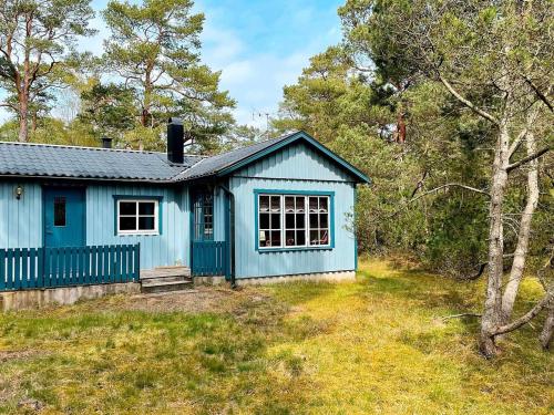 a blue tiny house in the woods at 4 person holiday home in YSTAD in Ystad