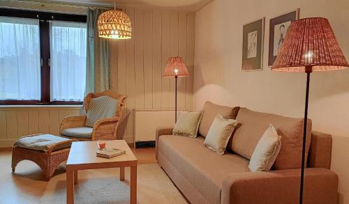 a living room with a couch and a chair at Ferienhof Rätzsee in Drosedow