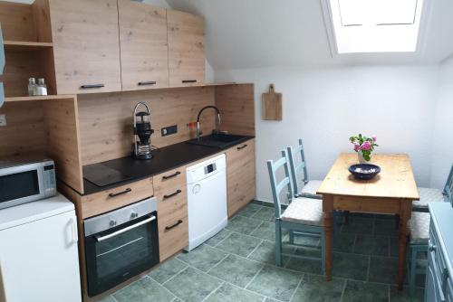 a kitchen with a small table and a wooden counter at Ferienhof Rätzsee in Drosedow