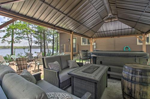 a screened in porch with a pool table and a pool piano at Loon Lake Lodge with Dock, Sauna and Hot Tub! in Pequot Lakes