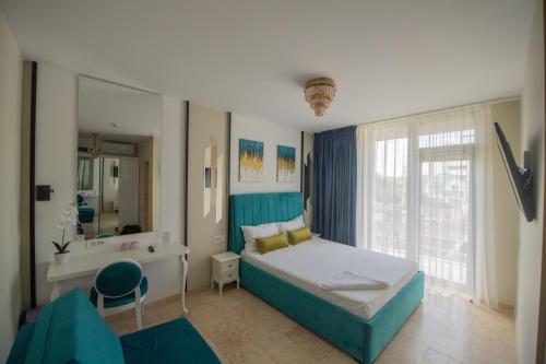 a bedroom with a bed and a sink and a mirror at Vila Ducu - Adults Only ( +16 ) in Mamaia Sat/Năvodari