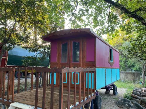 a toy train cabin sitting on a wooden deck at Les roulottes de Bayama - logement insolite avec jacuzzi in Mougins