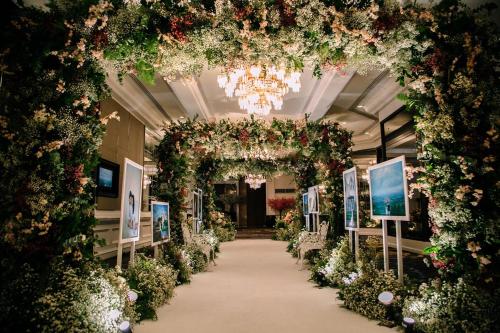 a hallway filled with flowers and plants in a building at Centara Grand at Central Plaza Ladprao Bangkok in Bangkok