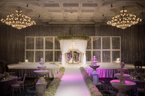 a banquet hall with purple tables and chandeliers at Centara Grand at Central Plaza Ladprao Bangkok in Bangkok