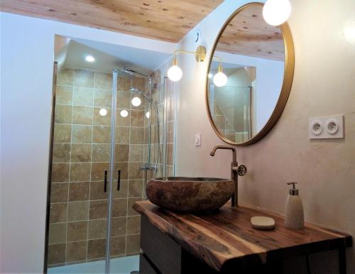 a bathroom with a stone sink and a mirror at Gite les Boleros in Queige