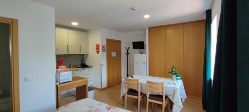 a kitchen with a table and chairs in a room at Get Cozy in Porto