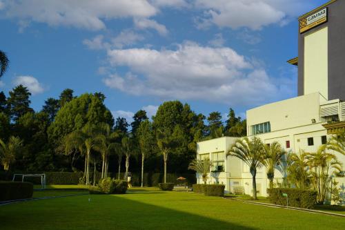 a building with a lawn in front of it at Gamma by Fiesta Americ Xalapa Nubara in Xalapa