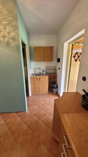 a kitchen with a tiled floor in a room at Domek nad stawami dla wędkarzy - Gospodarstwo Rybackie Jaworznik in Jaworznik