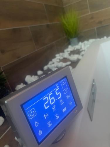 a digital clock sitting on a table in a bathroom at Fullmoon By Cloud in Aubervilliers
