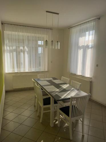 a dining room with a table and chairs at Apartament ZOSIA in Korczyna