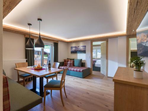 a living room with a table and a couch at Appartement Schwaiger in Scheffau am Wilden Kaiser
