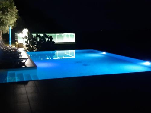 a swimming pool with blue lighting at night at Villa Greco in Rossano