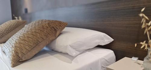 a bed with two pillows on top of it at Welcome Cagliari in Cagliari