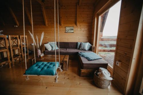a living room with a couch and a swing at Uvacki raj in Radijevići