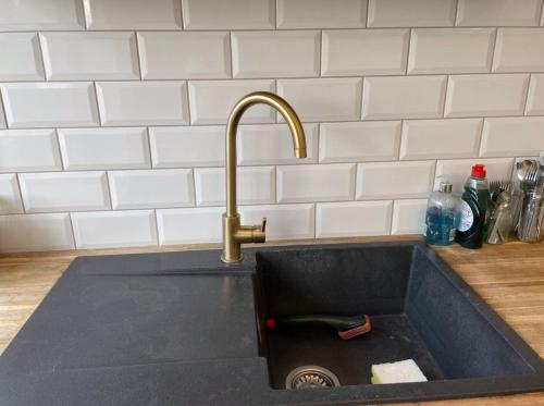 a sink with a faucet in a kitchen at Light Airy Detached Annex 2 Min Walk Train Station in Stowmarket