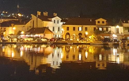 a group of buildings and a body of water at night at Kotor Center W in Kotor