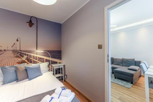 a bedroom with a bed and a view of the ocean at AP Apartments Piastowska in Gdańsk
