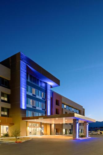an office building with blue lights on it at Holiday Inn Express & Suites Palm Desert - Millennium by IHG in Palm Desert