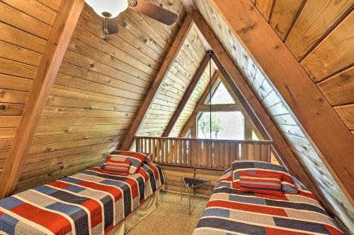 a bedroom with two beds in a wooden attic at Lake Pepin Cottage with Decks and Private Beach! in Stockholm