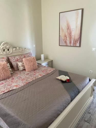 a bedroom with a large bed with pink pillows at Camere Infinity Rooms in Castelfidardo