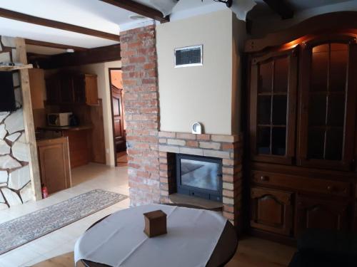 a living room with a brick fireplace and a table at P-4 in Retowo