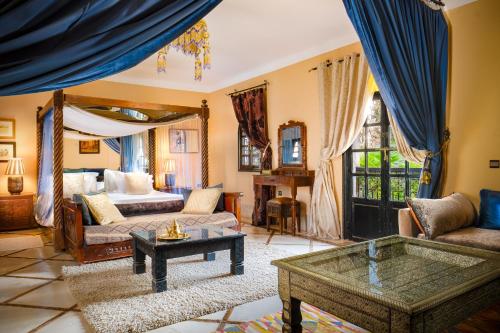 a living room with a bed and a coffee table at Riad et Kasbah Dar Ilham in Marrakech