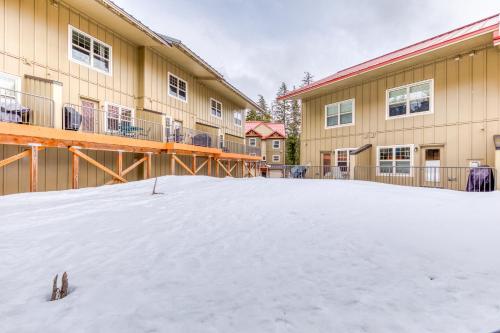 a snow covered yard in front of a building at Collins Lake Condo in Government Camp