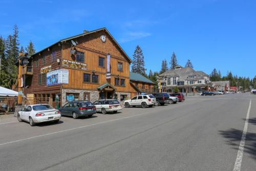 a large wooden building with cars parked on the side of a street at Collins Lake Condo in Government Camp
