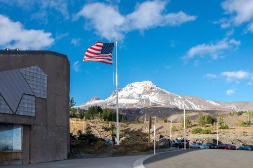an american flag flying in front of a mountain at Collins Lake Condo in Government Camp