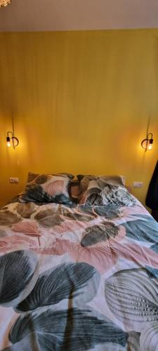 an unmade bed in a bedroom with two lights at Kasa d'Vizin in Paul
