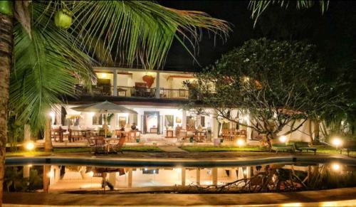 a house with a swimming pool at night at Kenyan House Malindi in Malindi