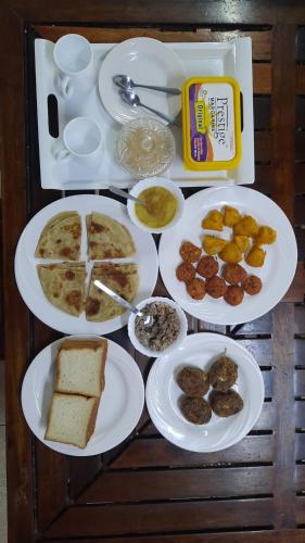 a table with plates of food on it at Kenyan House Malindi in Malindi