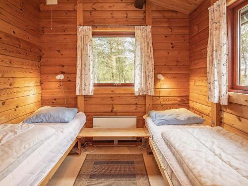 A bed or beds in a room at Four-Bedroom Holiday home in Roslev 3