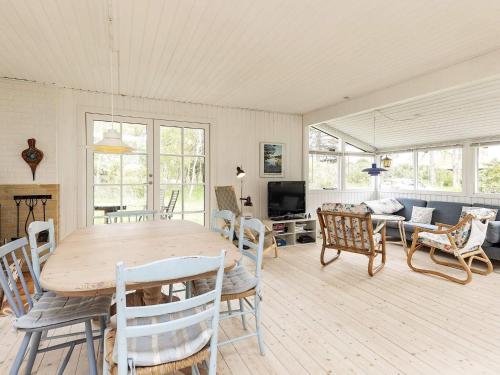 een woonkamer met een houten tafel en stoelen bij 6 person holiday home in Bindslev in Bindslev