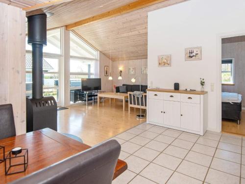 a kitchen and living room with a table and a fireplace at 6 person holiday home in Hemmet in Hemmet