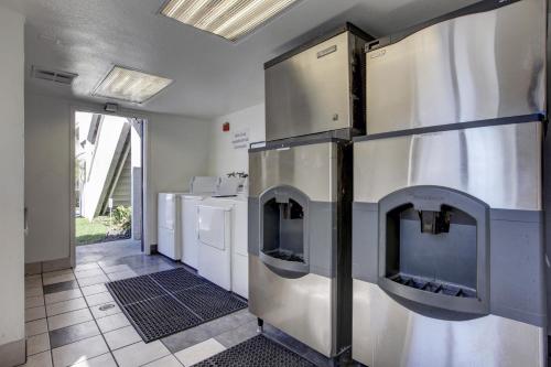 a large kitchen with a fireplace in a room at Motel 6-Bellflower, CA - Los Angeles in Bellflower