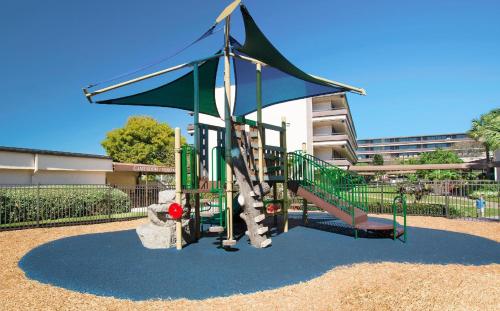 a playground with a slide in a park at Rosen Inn at Pointe Orlando in Orlando