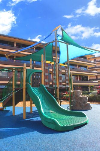 a playground with a slide in front of a building at Rosen Inn at Pointe Orlando in Orlando