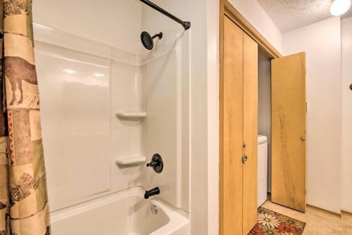a bathroom with a white tub and a shower at Deck and Resort Amenities Pocono Lake Home in Pocono Lake